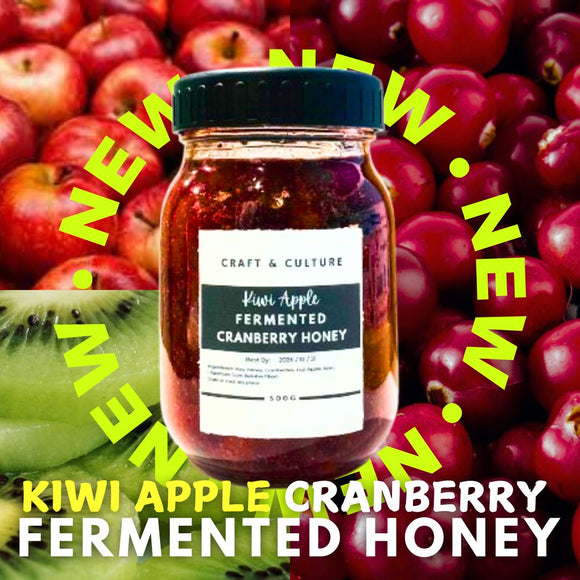 A jar of Craft & Culture - Kombucha, Kefir & Probiotics Singapore’s [New] Kiwi Apple Cranberry Fermented Honey sits before fresh apples and kiwis, with a yellow 