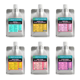 Six silver pouches of [SAMPLER 6] Black Tea Kombucha from Craft & Culture - Kombucha, Kefir & Probiotics Singapore feature flavors like Original, Ginger Chai, Rose Chai, Peach Nomo, Pink Lychee, and Kyoho Grape.