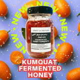 A jar of [NEW] Fermented Honey Kumquats Gift Set from Craft & Culture - Kombucha, Kefir & Probiotics Singapore sits among whole kumquats and orange stars, with "NEW" and "KUMQUAT FERMENTED HONEY" boldly encircling the jar.