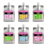 The [SAMPLER 6] Whole Milk Kefir by Craft & Culture - Kombucha, Kefir & Probiotics Singapore features six silver pouches in assorted flavors with colorful labels and white caps for a vibrant tasting experience.