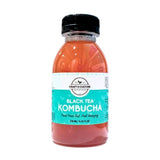 A clear plastic bottle with a black cap contains orange-brown kombucha. The label reads “Craft & Culture - Kombucha, Kefir & Probiotics Singapore [NEW] Pink Guava Black Tea Kombucha” and lists the volume as 250 mL (8.45 fl oz).