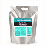 A silver stand-up pouch with a spout and handle displays a blue label reading “8 Day Kombucha ‘Bloat No More’ Detox, 1000 mL.” Enjoy refreshing detox and bloat relief benefits from Craft & Culture - Kombucha, Kefir & Probiotics Singapore.
