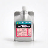 A silver pouch with a white cap labeled “Lychee Black Tea Kombucha” from Craft & Culture - Kombucha, Kefir & Probiotics Singapore stands upright, showing product details and nutrition facts on the label.