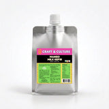A silver pouch with a spout labeled “Mango Whole Milk Kefir” from Craft & Culture - Kombucha, Kefir & Probiotics Singapore features a pink and black label above green nutritional info on a yellow-green background.