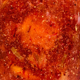 Close-up of Craft & Culture’s [NEW] Fermented Honey Kumquats Gift Set: a vibrant red-orange mixture with bubbles and green bits, showcasing this probiotic-rich treat from Kombucha, Kefir & Probiotics Singapore for natural immune support.